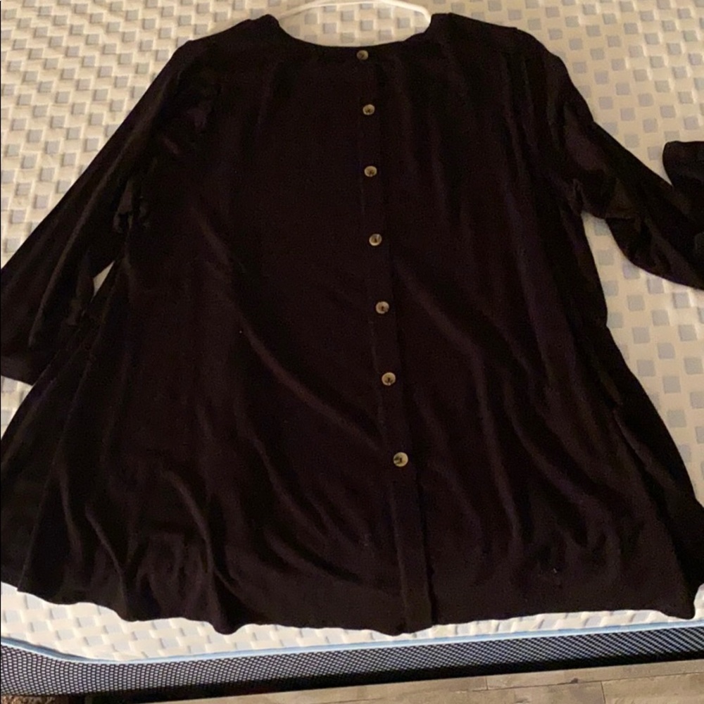 Black shirt with buttons going down back.